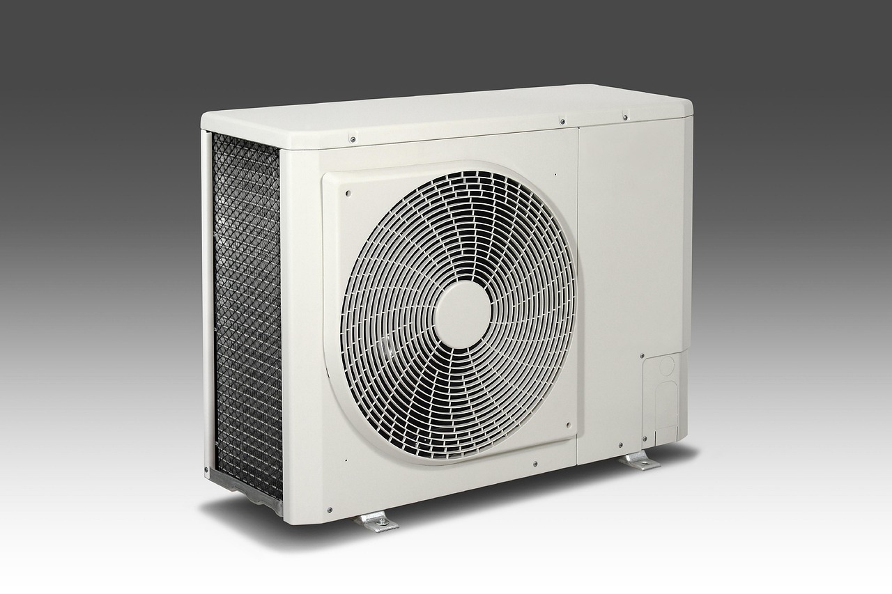 An outdoor AC condenser unit being serviced